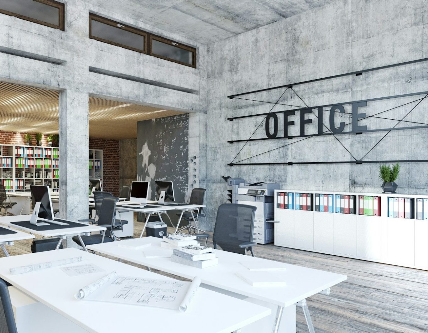 Oficina moderna con paredes de hormigón y mesas de trabajo minimalistas.